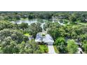 Aerial view of home on large treed lot, adjacent to a serene lake at 3610 Pershing Ave, Orlando, FL 32812