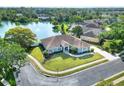 Stunning aerial view of home backing up to a tranquil pond with fountain and lush greenery at 5810 Lake Victoria Dr, Lakeland, FL 33813