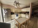 Well-lit kitchen with stainless steel appliances and dining area with tile flooring at 738 Adidas Rd, Winter Springs, FL 32708