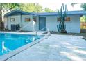 Backyard pool with concrete decking, privacy, and a desert cactus at 1501 7Th Se St, Winter Haven, FL 33880