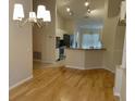 Spacious open-concept living area featuring hardwood floors and view into the eat in kitchen area at 1003 Clearpointe Way, Lakeland, FL 33813