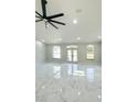 Bright living room with marble floors, three large windows and elegant double front door at 13619 Sw 78Th Pl, Dunnellon, FL 34432