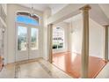 Elegant foyer with soaring ceilings, decorative columns, and an abundance of natural light at 1125 English Garden Ln, Winter Garden, FL 34787