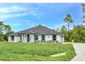 Charming single-story home featuring a well-maintained lawn and landscaping, with a side entry garage at 19073 Sabal St, Orlando, FL 32833