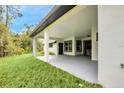 Relaxing covered patio for outdoor living with ample space and a view of the lush backyard at 19073 Sabal St, Orlando, FL 32833