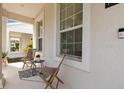 Inviting front porch with chairs, perfect for relaxing and enjoying the neighborhood at 11865 Ginsberg Pl, Orlando, FL 32832