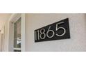 Close-up of the house number '11865' in a modern, easy-to-read font at 11865 Ginsberg Pl, Orlando, FL 32832