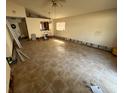 Open concept living room features tile flooring, ceiling fan, and natural light at 13026 Baltimore Woods Ln, Orlando, FL 32824