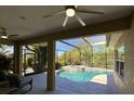 Inviting outdoor pool area with a covered patio, perfect for entertaining or relaxation at 9632 Spring Lake Dr, Clermont, FL 34711