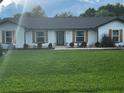 Lovely home featuring a meticulously maintained green lawn, white exterior, and classic shutters at 1114 Dove Ln, Winter Springs, FL 32708