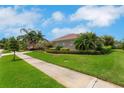Well-maintained single-story home with lush green grass, a tidy landscaped flowerbed, and a concrete sidewalk at 508 Bacio St, New Smyrna Beach, FL 32168