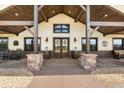 Inviting covered entryway features stone pillars, wooden beams, and double doors at 11657 Moore Rd, Lakeland, FL 33809