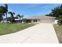Attractive home with a concrete driveway complemented by a well-maintained lawn and attractive landscaping elements at 2521 Tamarind Dr, Edgewater, FL 32141