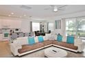 Open-concept living room with modern furnishings and seamless flow to the kitchen and dining area at 4500 Monado Dr, Kissimmee, FL 34746