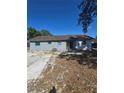 Rear exterior of home with a yard and patio at 605 Maggie Cir, Winter Haven, FL 33880