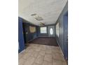 The living room area features tile and carpet flooring at 605 Maggie Cir, Winter Haven, FL 33880