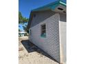 Side exterior of the home showing brick and window details at 605 Maggie Cir, Winter Haven, FL 33880