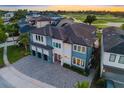 Beautiful aerial view of a modern home showcasing its three-car garage and landscaped surroundings at 1514 Corolla Ct, Reunion, FL 34747