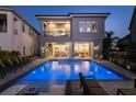 Stunning backyard oasis with a luxurious pool, spa, comfortable lounge chairs, and a covered patio at 1514 Corolla Ct, Reunion, FL 34747