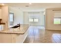 Bright and airy kitchen and dining area with granite countertops and tile flooring at 5216 Greenheart Ave, Mount Dora, FL 32757