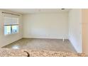 Bright living room featuring tile floors and a large window with natural light at 5216 Greenheart Ave, Mount Dora, FL 32757