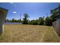 Expansive backyard with potential for landscaping and outdoor activities, surrounded by mature trees and a privacy fence at 13257 Sw 29Th Cir, Ocala, FL 34473