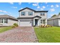 Charming two-story home with a brick driveway and well-maintained landscaping at 3153 Legends Preserve Dr, Daytona Beach, FL 32124