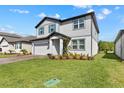 Inviting two-story home with lush green lawn and well-kept front yard at 3153 Legends Preserve Dr, Daytona Beach, FL 32124