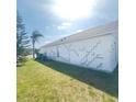 Exterior wall of home showing cosmetic damage and lawn at 323 Miami Ln, Kissimmee, FL 34759