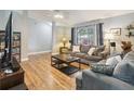 Comfortable living room with wood floors, neutral paint, and large windows creates a relaxed atmosphere at 5003 Timber Ridge Trl, Ocoee, FL 34761
