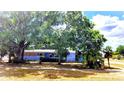 Charming single-story home with mature trees and a lawn at 902 S Scenic Hwy, Lake Wales, FL 33853