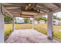 View from inside the carport looking out to the backyard and neighboring homes at 515 New York Ave, St Cloud, FL 34769