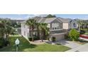 Expansive view showcasing the home's architectural design, landscaping, and surrounding neighborhood at 13532 Meadow Bay Loop, Orlando, FL 32824