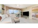 Stylish living room with neutral walls, large window, and seamless access to bedroom at 4 Oceans West Blvd # 502B, Daytona Beach, FL 32118