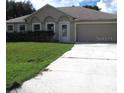 Well-kept one-story home with an attached two-car garage and concrete driveway at 1118 Perpignan Ct, Kissimmee, FL 34759