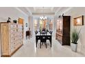 Formal dining room with elegant chandelier, classic furniture, and a large window for natural light at 8749 The Esplanade # 6, Orlando, FL 32836