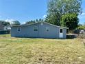 Large backyard with green grass, providing ample space for outdoor activities at 311 James Ave, Auburndale, FL 33823