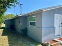Side of the house with a clean exterior, showcasing a well-maintained property with a modern look at 311 James Ave, Auburndale, FL 33823
