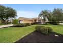 Well-maintained single-story home with manicured lawn and decorative mulch beds at 8166 Sw 80Th Ter, Ocala, FL 34476