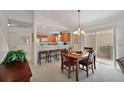Cozy dining area adjacent to the kitchen with a view of the outdoor patio at 1787 Foliage Ln, The Villages, FL 32162