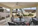 Relaxing screened-in patio with ceiling fan and comfortable outdoor seating arrangement at 1787 Foliage Ln, The Villages, FL 32162