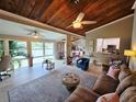 Inviting living room featuring a cozy brown sofa and large windows with scenic waterfront views at 200 Maitland Ave # 114, Altamonte Springs, FL 32701