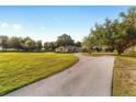 Expansive front yard with long driveway leading up to a single story home at 2899 Sw 66 St, Ocala, FL 34476