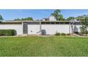 The backyard features a well-maintained lawn, privacy fence, and air conditioning unit at 2049 Se 37Th Court Cir, Ocala, FL 34471