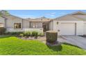 Charming single-story home featuring a well-manicured lawn and inviting front entrance at 2049 Se 37Th Court Cir, Ocala, FL 34471