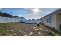 Large backyard enclosed by a white fence, offering privacy and ample space at 224 Nova Dr, Davenport, FL 33837