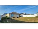 Spacious backyard with potential for landscaping, featuring a privacy fence at 224 Nova Dr, Davenport, FL 33837