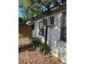 Exterior view of the side of the home showing an air conditioning unit at 5429 Vanderlin St, Orlando, FL 32810