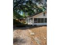 Exterior view of the home with stone walkway leading to the entrance and yard with fallen leaves at 5429 Vanderlin St, Orlando, FL 32810