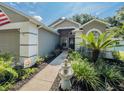 Charming home featuring a fountain, well-manicured landscaping, and a paver walkway at 3905 Westerham Dr, Clermont, FL 34711